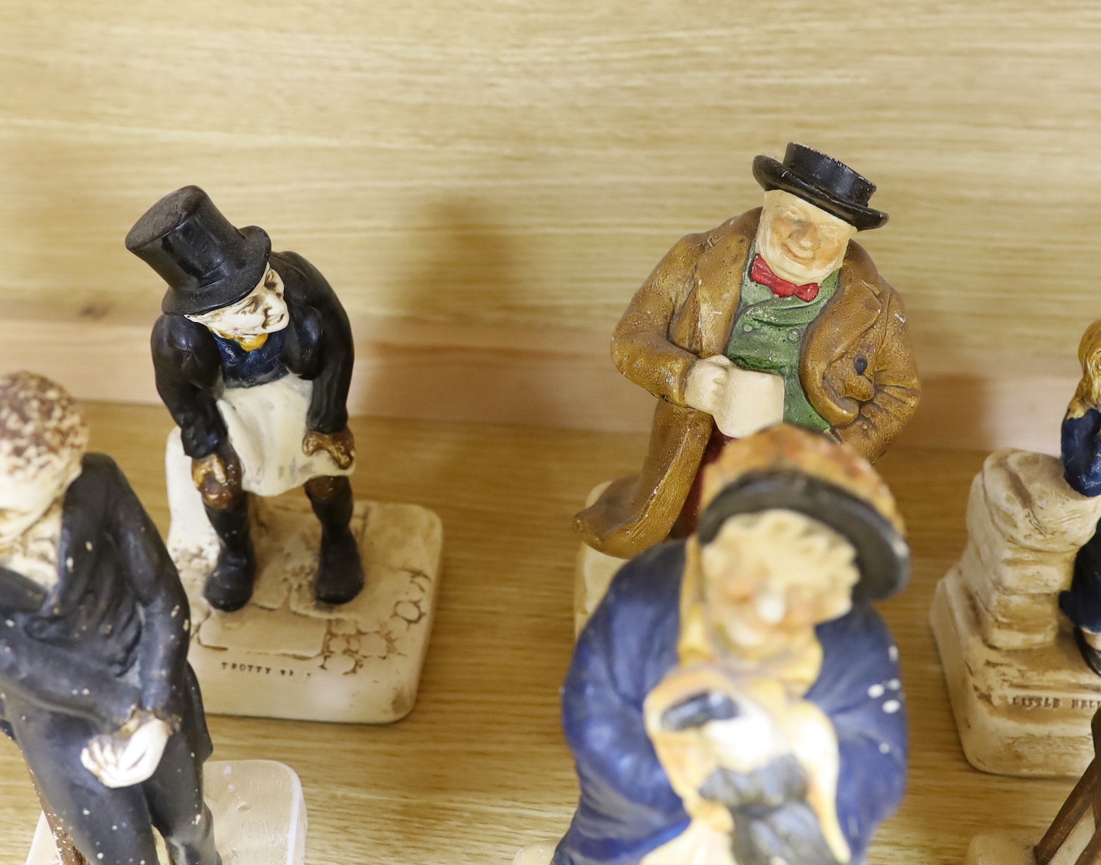 A collection of twelve Bretby cold painted pottery Dickens character figures, tallest Mr. Micawbee 25cm high